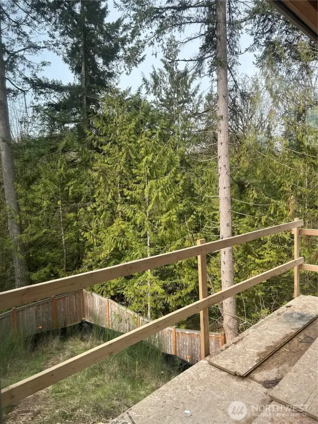 Partially completed back deck and sloped back yard.