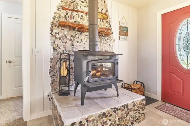 Woodstove with river rock backing