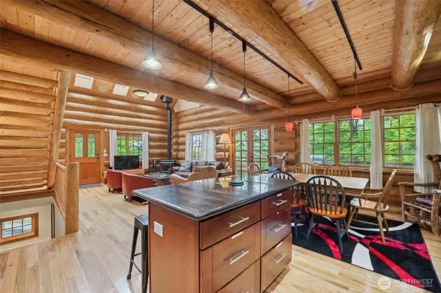 The kitchen looks out over the dining and living rooms and has access to the expansive deck with a view!