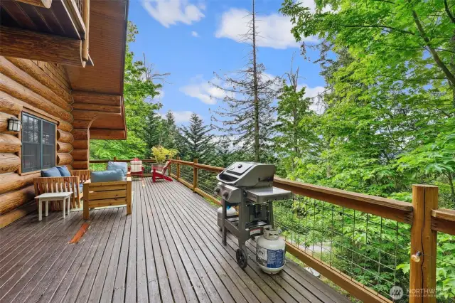 The beautiful expansive deck has water and mountain views.  Feel perched on top of the world overlooking your 2.6 acres.