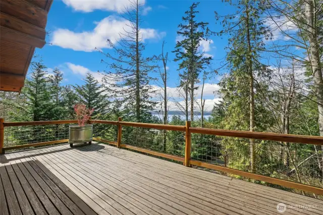 The beautiful expansive deck has water and mountain views.  Feel perched on top of the world overlooking your 2.6 acres.