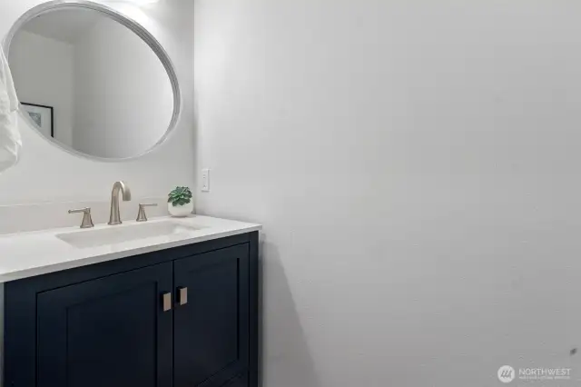 A quarter bath (toilet and sink) is next to the laundry and across from the garage.