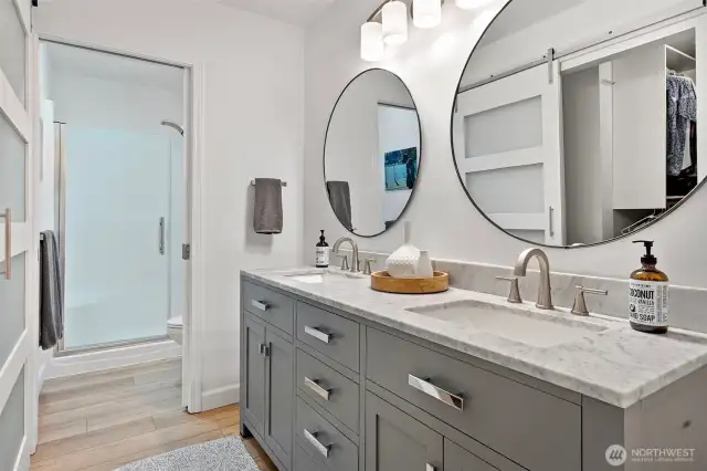Dual sinks and quartz counters await in this remodeled primary bathroom.