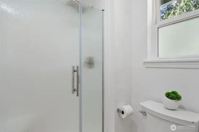 The primary bathroom has a closed off area with the toilet and shower stall.