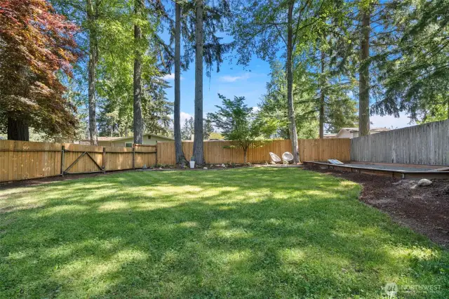 A large grassy area to the east of the home with a sand bocce and cornhole court.