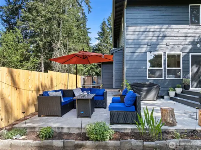The large stamped concrete patio curves around the west side of the home.