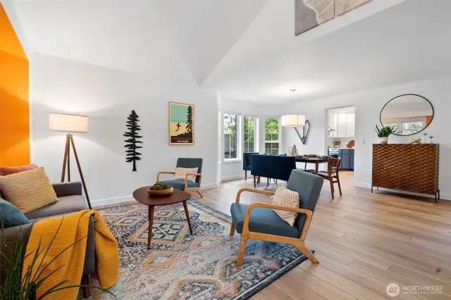 Upon entering the home you are greeted with an expansive living room and dining room with vaulted ceilings.