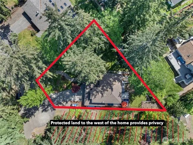 Quarter-acre lot with protected land to the west promotes privacy.