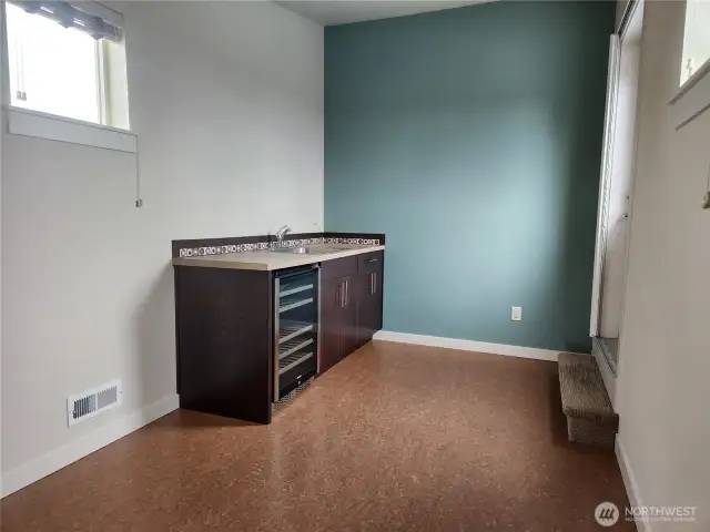 Up to the roof top deck. Landing has a handy wet bar.