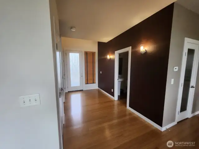 Entry way to the home, powder to the right of the photo and left are stairs to second floor and closet with tons of space for storage.