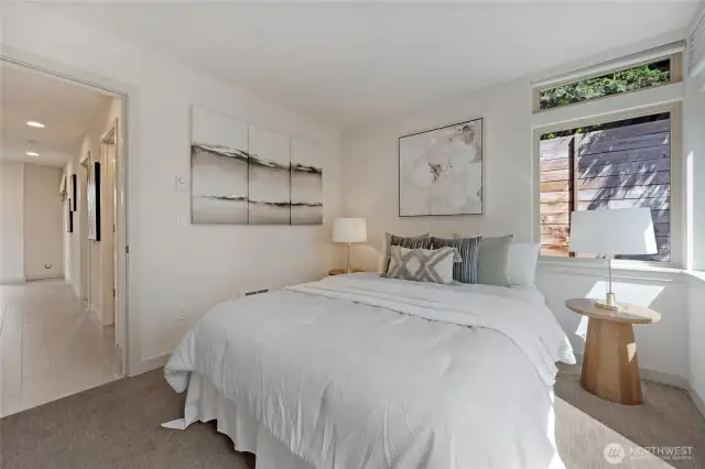 Bedroom one on the main floor is a large bedroom with good light, double closets, and a slider out to the back patio and garden area.