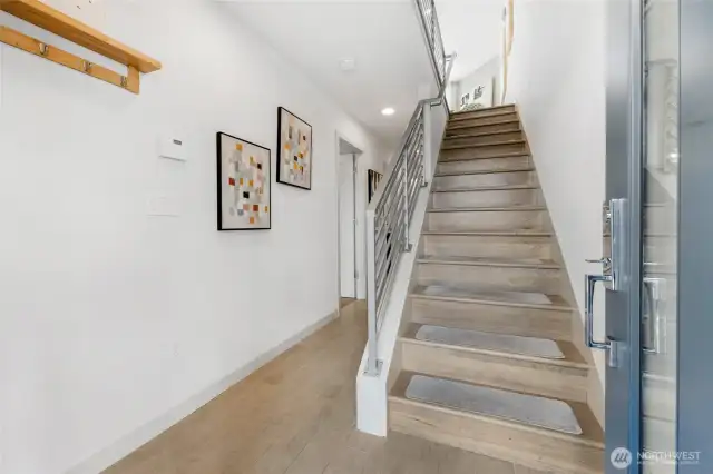The entry level with the 2 bedrooms, full bath, Laundry Closet with full size W&D, ascend the designer floating stairway to the main living area.
