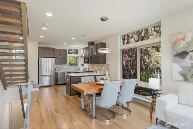 Dining area enjoy the garden views.  Designer lighting and recessed lighting brightens the space. Room for a bigger table than shown.