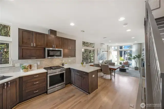 Kitchen opens and flows to the rest of the main living area.  Abundance of quality cabinetry with quartz counter tops. Jenn-Aire gas cooktop and range.