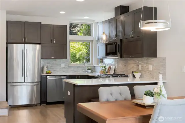 Seating counter looking in.  Full tiled back splash and natural light from the kitchen windows.