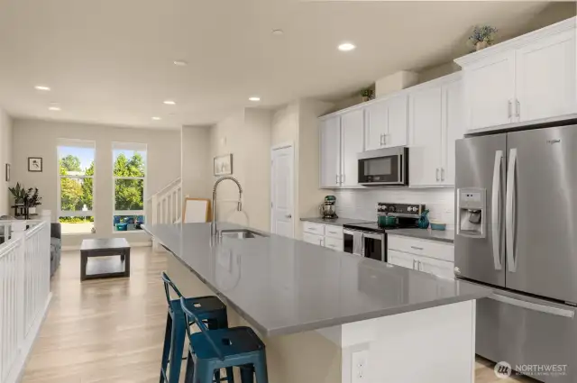 Designed for both function and style, the open-concept main level boasts quartz countertops and generous storage throughout, including a walk-in pantry you’ll love.