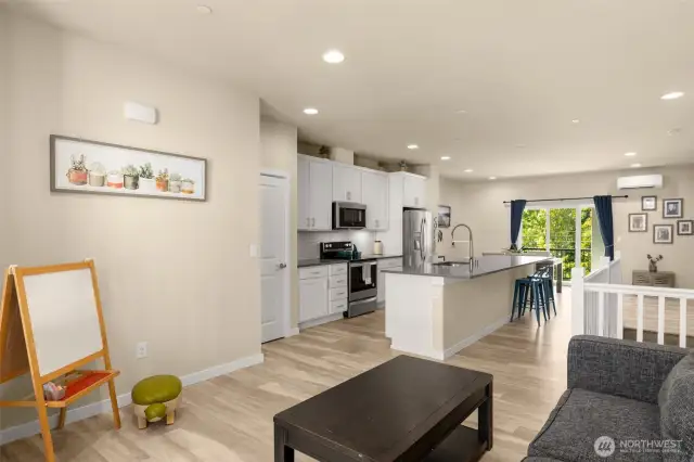 The main-level living room sits just beyond the kitchen—ideal for keeping the conversation going while cooking or hosting.