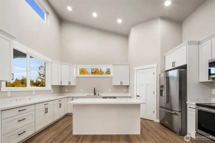 Chefs kitchen showcasing quartz slab counters...