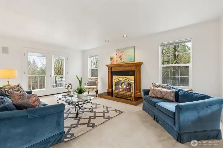 The formal living room surrounded by large, windows is a peaceful retreat from the busy household. Timeless French doors lead to the back covered patio. The handsome wood wrap fireplace has not been used by this owner.