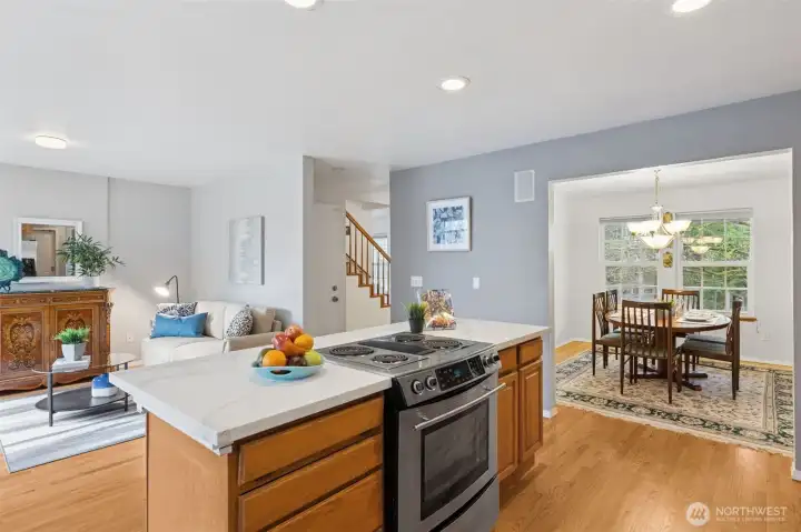 Rich hardwood floors continue through the dining into the great room/kitchen space. The easy circular flow of the floor plan makes for easy entertaining for large groups. Find the lower level entry in the center hallway.