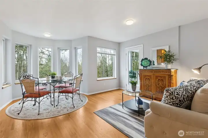 The bay eating space and great room seating area look out toward the back of the property and a serene woodland view, soon to come alive as the deciduous trees take bloom. Fantastic privacy and comfort.