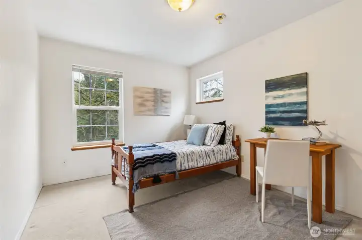The second of the three additional bedrooms, stretches to a longer depth. Not seen is the large, deep double door closet for extra storage in this corner bedroom.