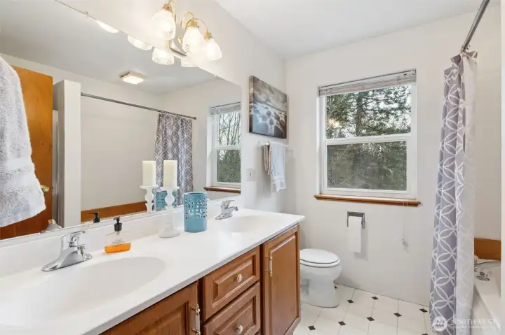 The secondary bath also features a two sink vanity and step in tub/shower combination bathing option.