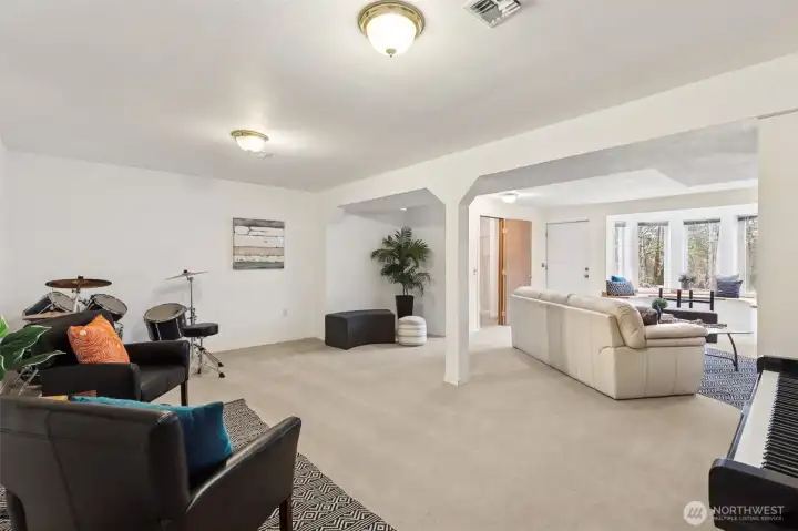A view of the lower level living with the entry access door and 3/4 bath door at the top center of the photo.