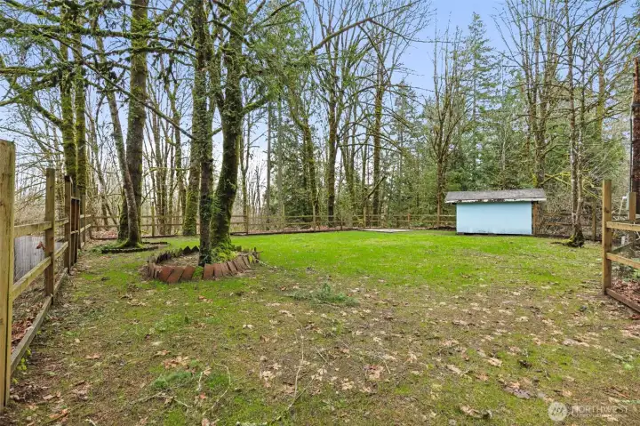 The level fenced yard also includes the drain field area and a storage shed. A portion of this section may be considered Thurston County while the other areas of the lot are considered City of Tumwater.
