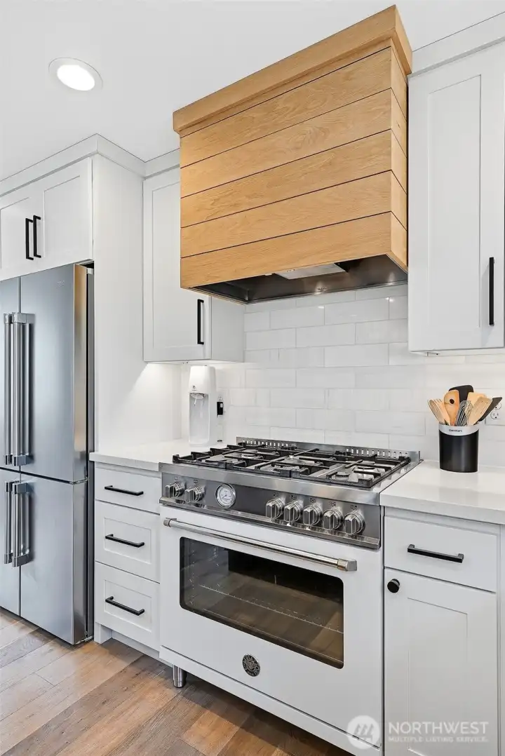 Bertazzoni 5-burner gas range with vent hood wrapped in white oak