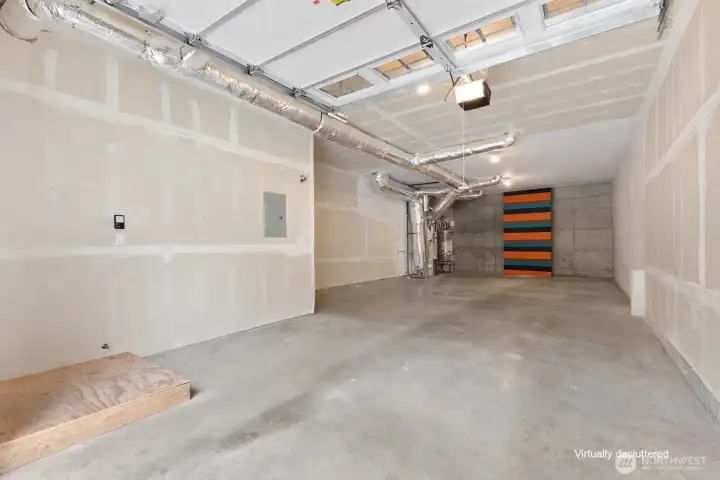 Virtually decluttered 2 car tandem garage with large workshop area and panels to hide shelving at back if you desire to add shelves.