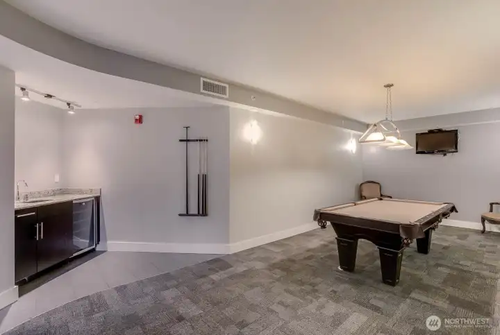 Community room with pool table, fireplace, kitchen prep area