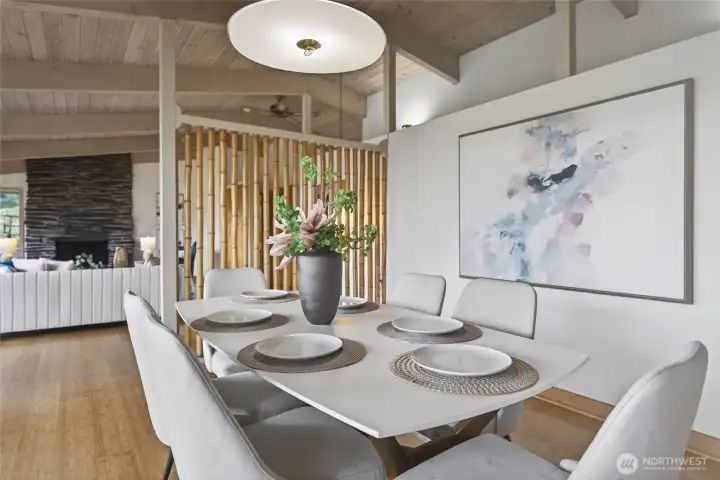 The dining area is defined by the bamboo but open to the large living room.