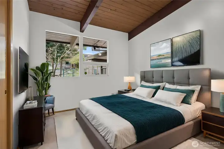 Virtually staged 2nd Bedroom on main level with vaulted ceiling.