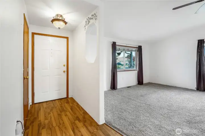 The front doorway has plenty of light, and includes an opening into the living room where you can set your keys so you don't forget them.