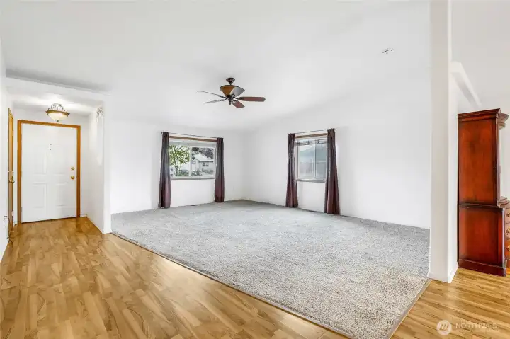 A view of the living room from the kitchen. Lots of natural light from the front and side windows here.