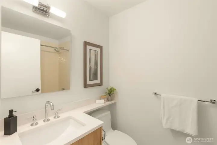 Beautifully remodeled full bathroom with tile tub surround.
