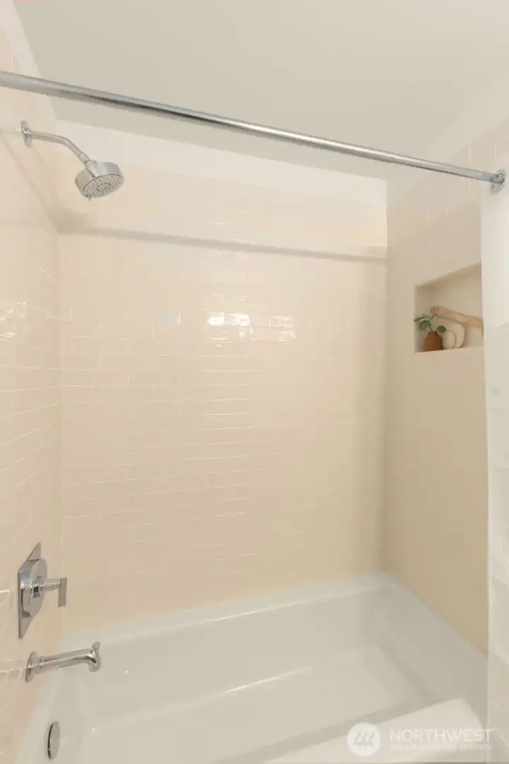 Beautifully remodeled full bathroom with tile tub surround.