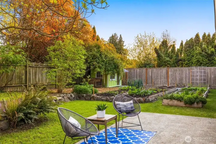 Outdoors, the gardener’s paradise offers mature raised beds brimming with vegetables and greens, an adorable playhouse or potting shed, and composter.