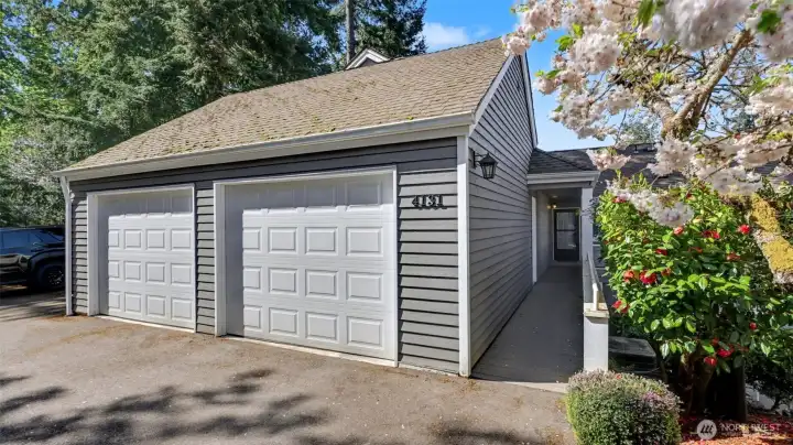 2 car garage with 2 shared guest parking spaces.