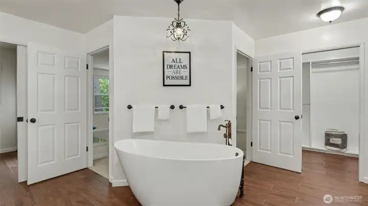 High end soaker tub anchors the primary bathroom.