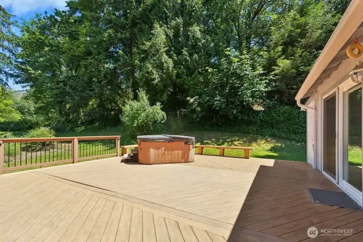 Large TimberTech deck with hot tub overlooks acre+ lot with sweeping views. Large TimberTech deck with hot tub overlooks acre+ lot with sweeping views.
