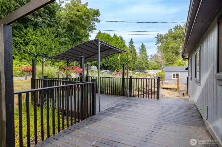 Large front deck in front of the main home with covered sitting area