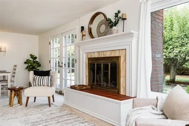 French doors and a gorgeous fireplace create an enchanting room.