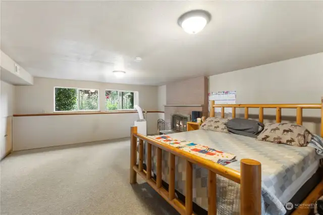 Large bonus room downstairs with wood burning fireplace and extra storage cabinet.