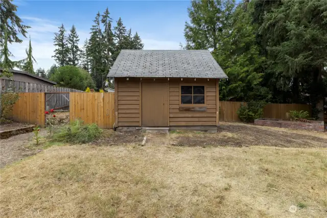 Large shed in backyard has a loft area with stairs for storage plus room for your garden tools! For you chicken lovers, the left side is a chicken coop or extra space for your imagination!