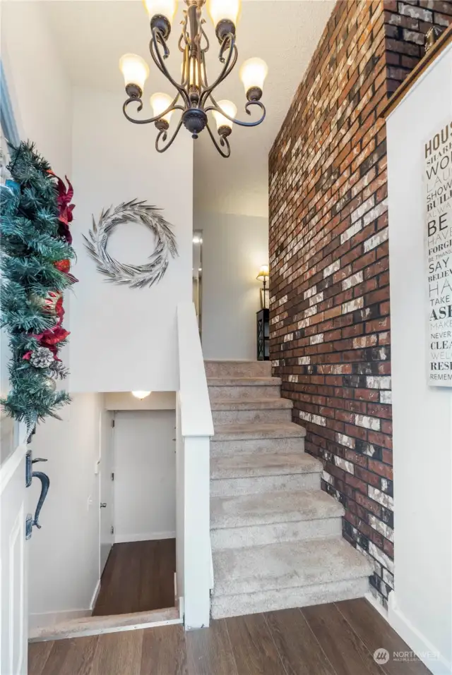 Soaring ceilings and a beautiful light fixture grace the entryway