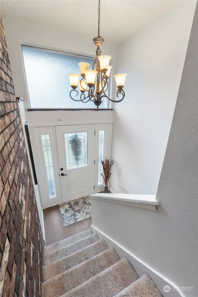 A gorgeous entry door with inlaid glass welcomes you to this charming home