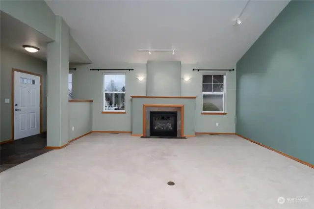 Large living room features vaulted ceilings and gas fireplace.