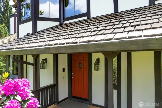 covered sdwalkway and porch leading to the front door